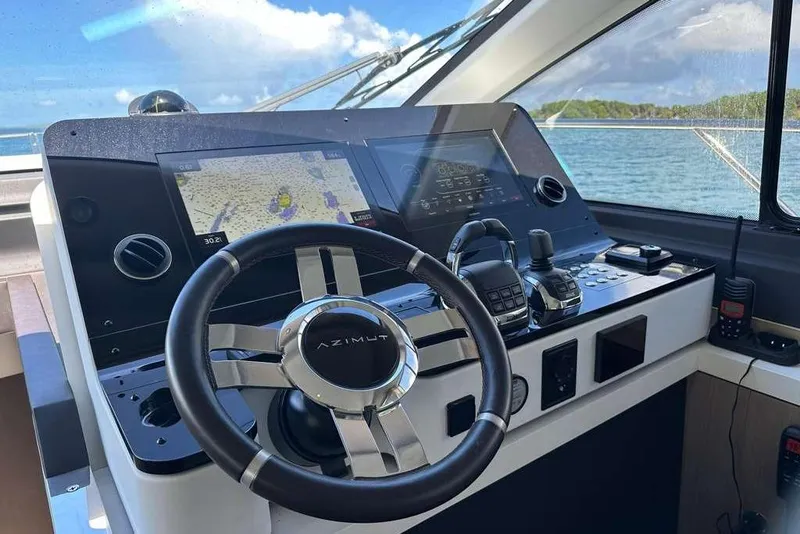 Slide: The Image of Cockpit of 2021 Azimut Fly 60 yacht with modern navigation controls and steering wheel. - 32