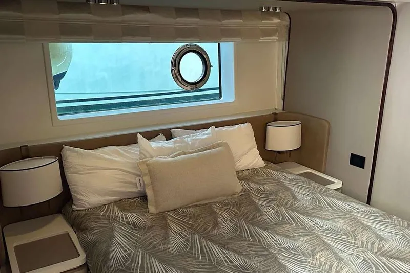 Slide: The Image of Luxurious bedroom interior of 2021 Azimut Fly 60 yacht with elegant bedding and porthole window. - 4