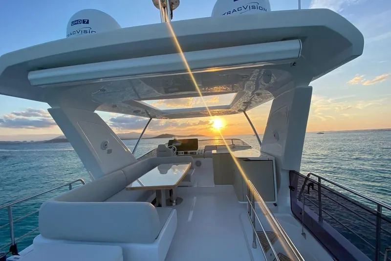 Slide: The Image of Luxurious 2021 Azimut Fly 60 yacht at sunset, featuring elegant seating and ocean views. - 5