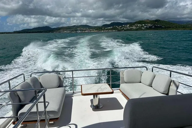 Slide: The Image of Azimut Fly 60 yacht cruising, featuring luxurious seating and ocean view, 2021 model. - 6