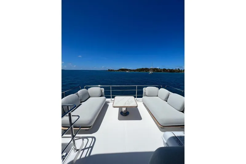 Slide: The Image of Luxurious Azimut Fly 60 yacht deck with seating, overlooking serene ocean view. - 7