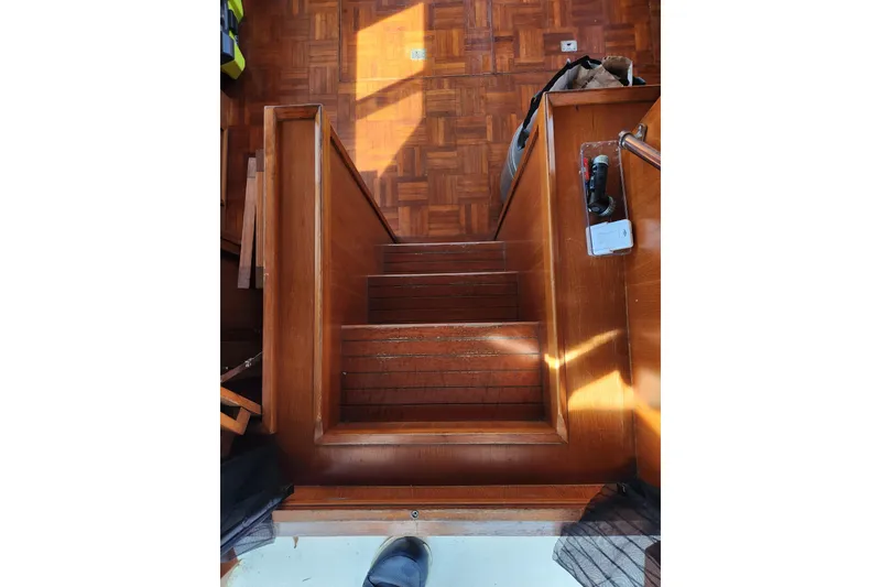 Slide: The Image of Staircase inside 1987 Jefferson 42 SE Sundeck Motor Yacht with wooden flooring. - 16