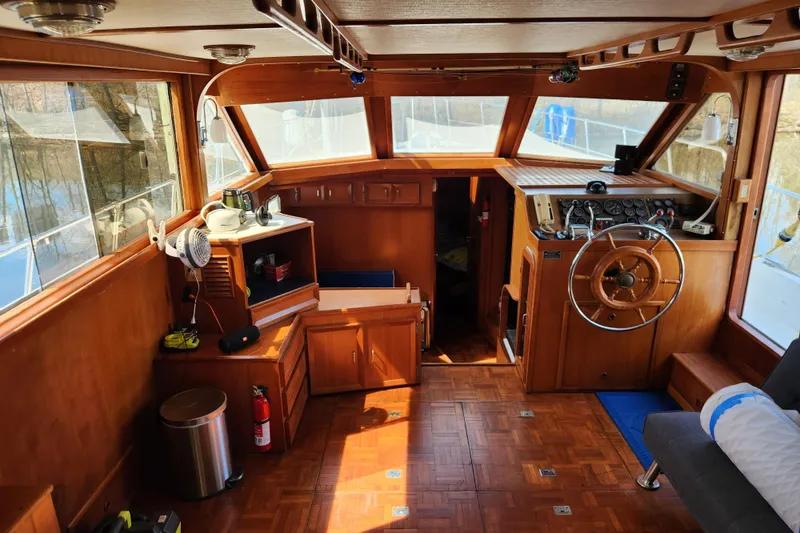 Slide: The Image of Interior of 1987 Jefferson 42 SE Sundeck Motor Yacht with wooden helm and seating area. - 17
