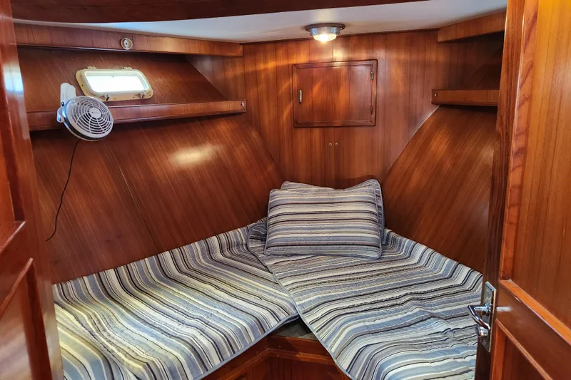 Slide: The Image of Cozy cabin interior of 1987 Jefferson 42 SE Sundeck Motor Yacht with striped bedding. - 28