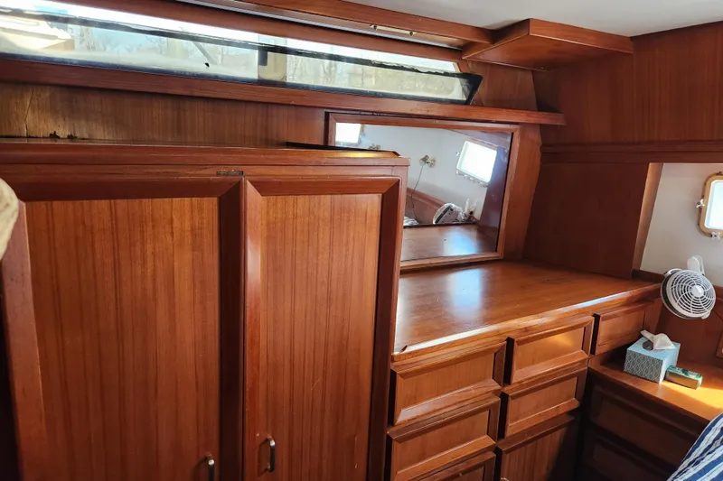 Slide: The Image of Interior of 1987 Jefferson 42 SE Sundeck Motor Yacht with wooden cabinetry and mirror. - 31