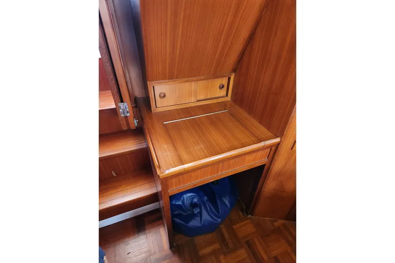 Slide: The Image of 1987 Jefferson 42 SE Sundeck Motor Yacht interior with wooden desk and storage. - 34