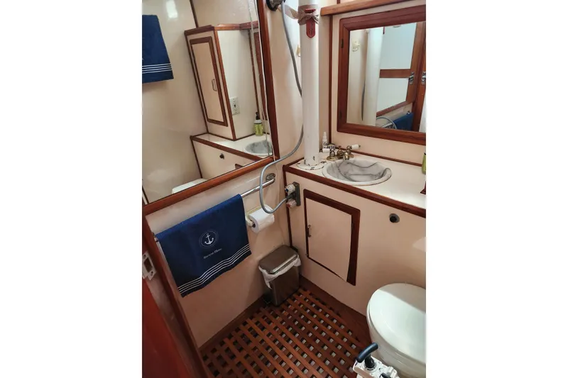 Slide: The Image of Bathroom interior of 1987 Jefferson 42 SE Sundeck Motor Yacht, featuring wood accents and nautical decor. - 41