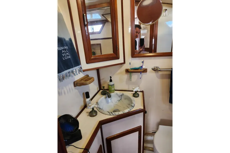 Slide: The Image of Bathroom interior of 1987 Jefferson 42 SE Sundeck Motor Yacht with sink and mirror. - 42