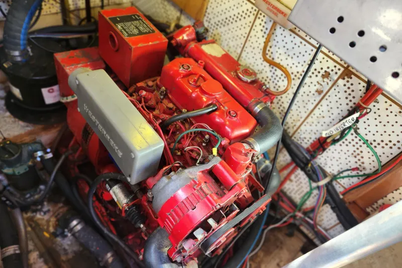 Slide: The Image of Engine room of 1987 Jefferson 42 SE Sundeck Motor Yacht with red machinery. - 49