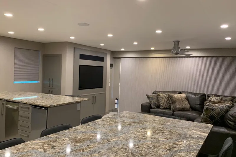Slide: The Image of Modern living area with granite countertops, leather sofa, and recessed lighting, Adonia Harmony Trip 2020. - 16