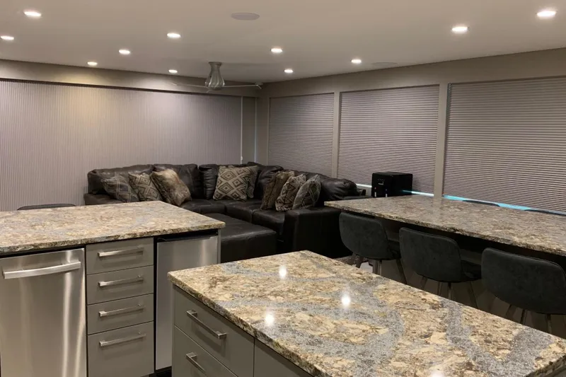 Slide: The Image of Modern kitchen with granite countertops, stainless steel appliances, and cozy seating area. - 17