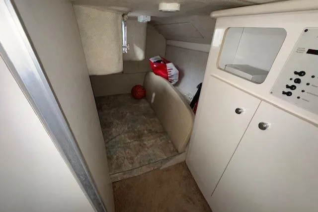 Slide: The Image of Interior cabin of 2001 Bayliner 2855 Ciera boat, featuring storage and control panel. - 11
