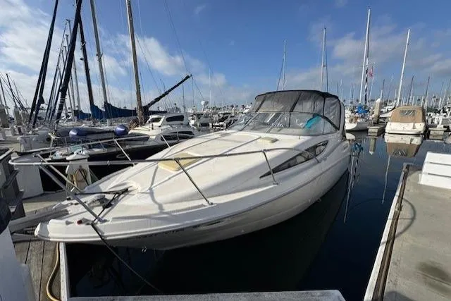 Slide: The Image of 2001 Bayliner 2855 Ciera docked at a marina under a clear blue sky. - 4