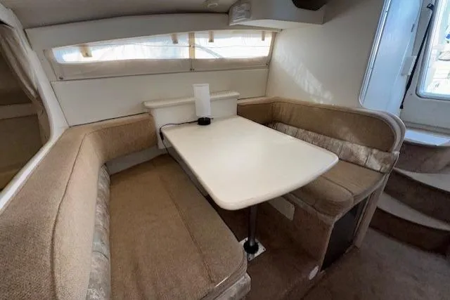 Slide: The Image of Interior of 2001 Bayliner 2855 Ciera with cozy dining area and beige seating. - 5