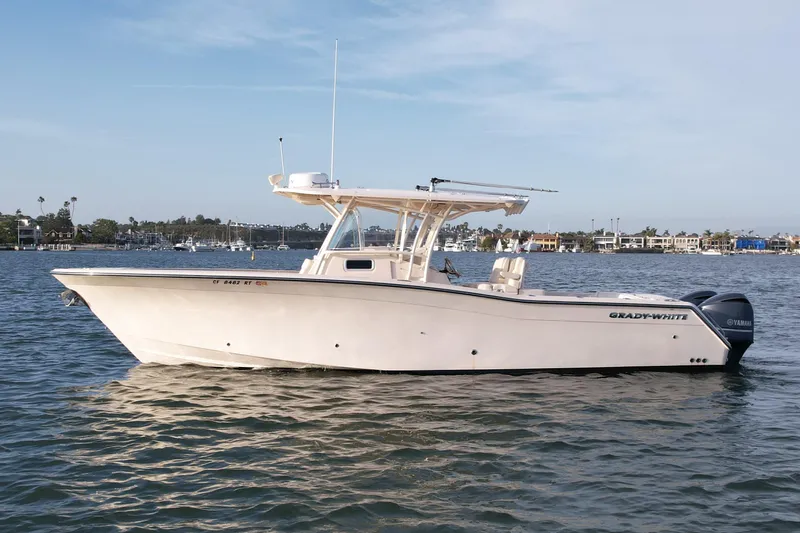 The Image of 2012 Grady-White Canyon 336 boat on calm water, side view. - 0
