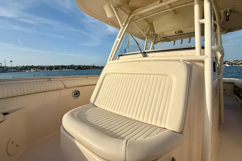 Slide: The Image of 2012 Grady-White Canyon 336 boat interior with cushioned seating, overlooking serene waters. - 11