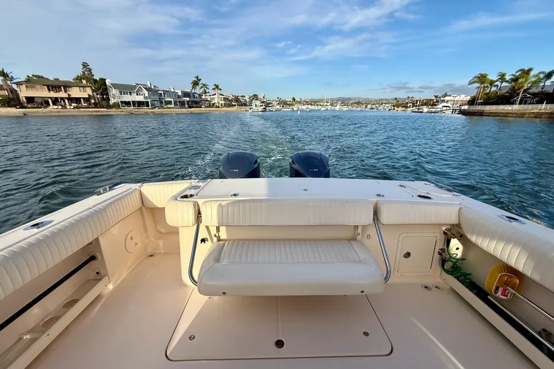 Slide: The Image of 2012 Grady-White Canyon 336 boat on water, coastal homes in background. - 14
