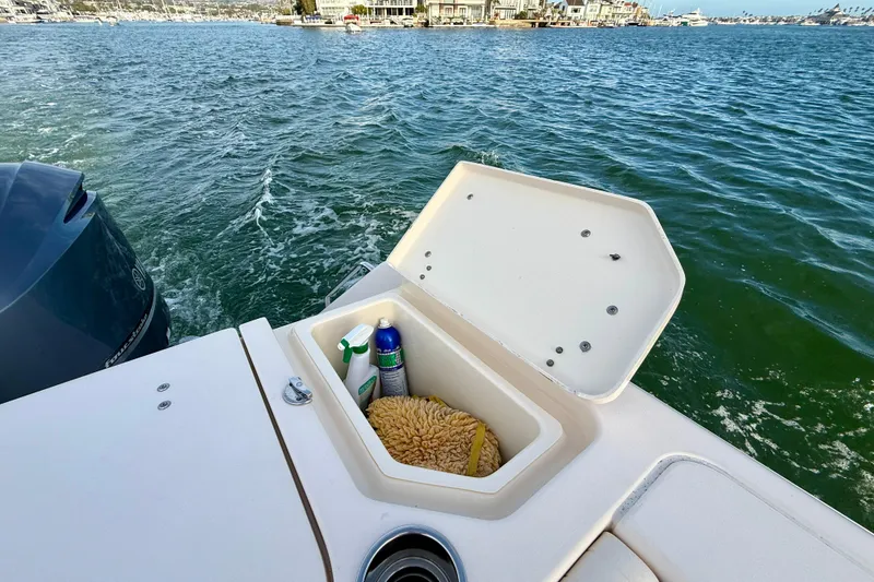 Slide: The Image of 2012 Grady-White Canyon 336 boat with open storage compartment on the water. - 16