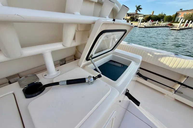 Slide: The Image of 2012 Grady-White Canyon 336 boat with open storage compartment by the water. - 17