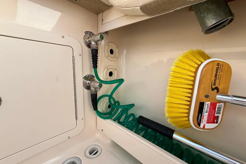 Slide: The Image of 2012 Grady-White Canyon 336 boat deck with hose and Shurhold deck brush. - 19