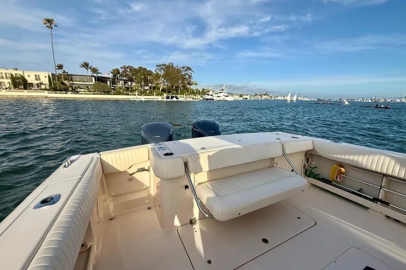 Slide: The Image of 2012 Grady-White Canyon 336 boat on calm waters near a scenic shoreline. - 23