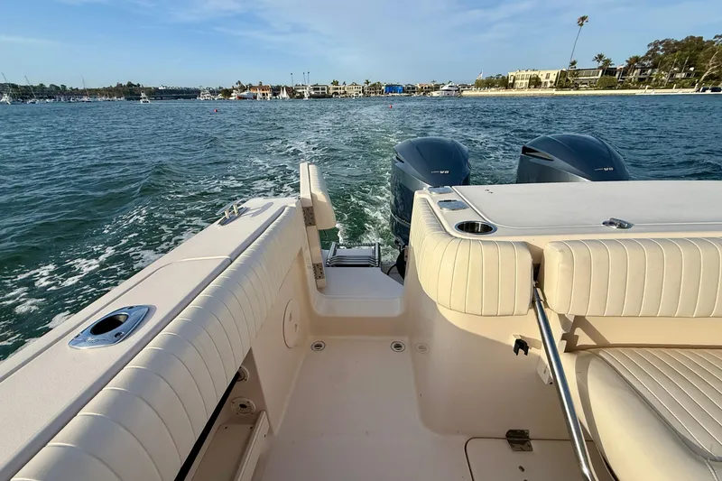 Slide: The Image of 2012 Grady-White Canyon 336 boat interior with twin engines on open water. - 25