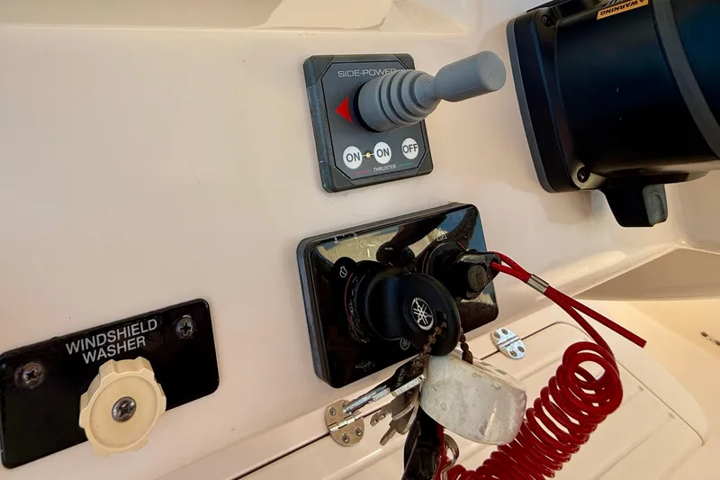 Slide: The Image of Control panel of a 2012 Grady-White Canyon 336 boat with keys and switches. - 35