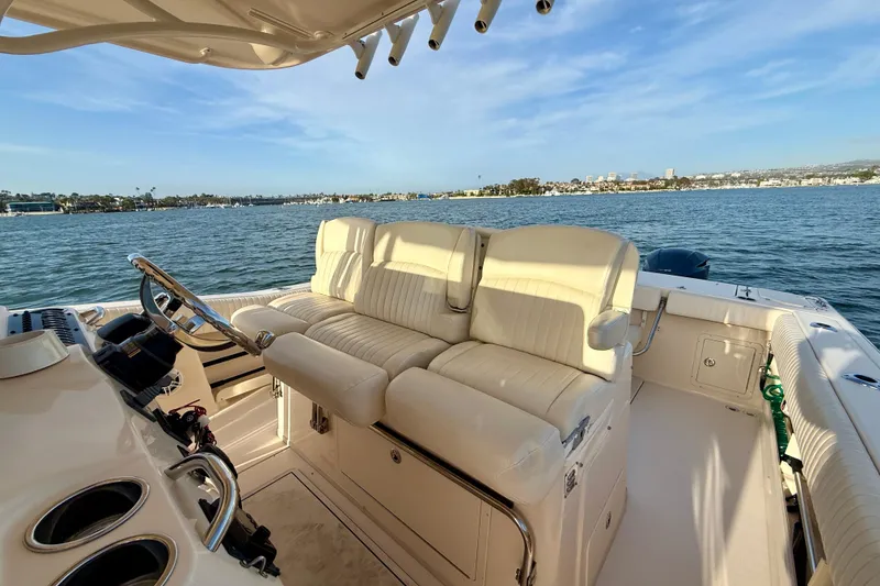 Slide: The Image of 2012 Grady-White Canyon 336 boat interior with plush seating, overlooking serene waters. - 39