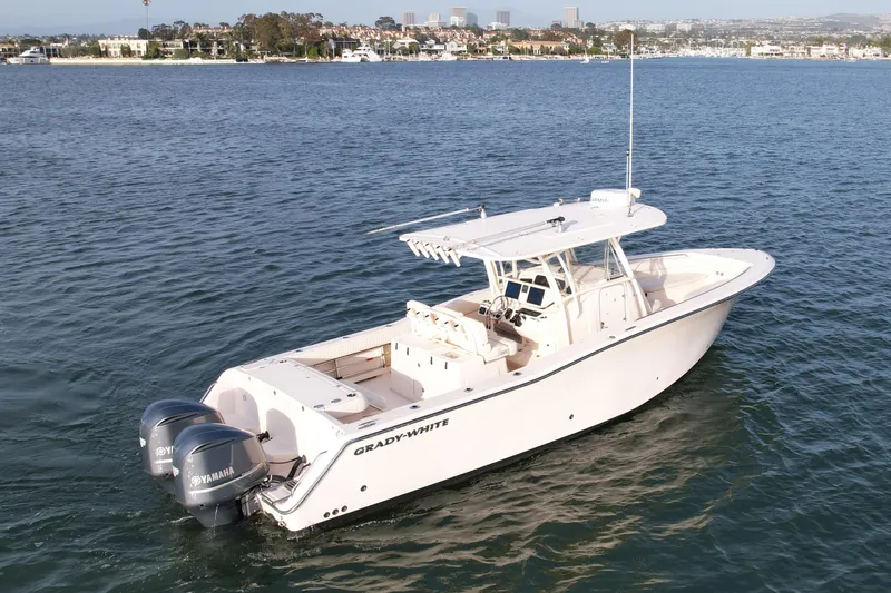 Slide: The Image of 2012 Grady-White Canyon 336 boat on calm water, featuring twin Yamaha engines. - 4