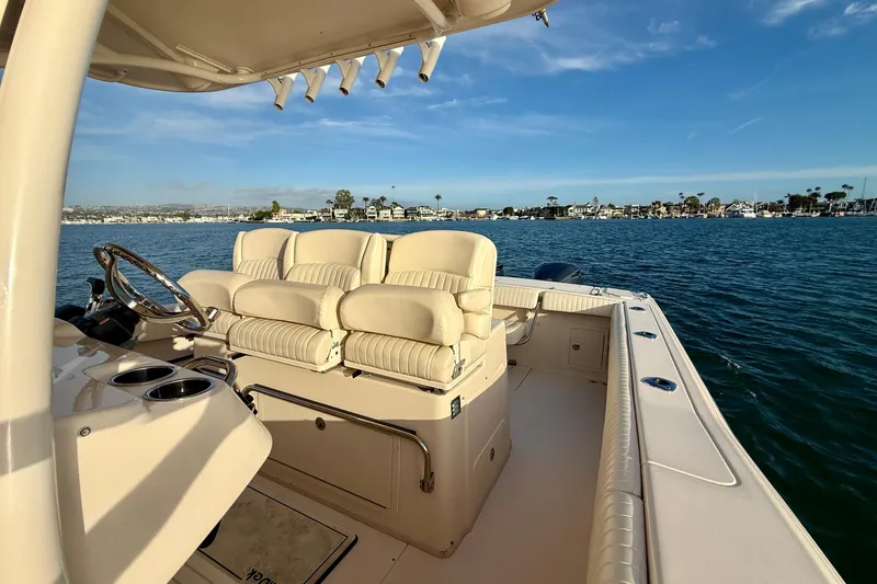 Slide: The Image of 2012 Grady-White Canyon 336 boat interior with plush seating on calm water. - 40