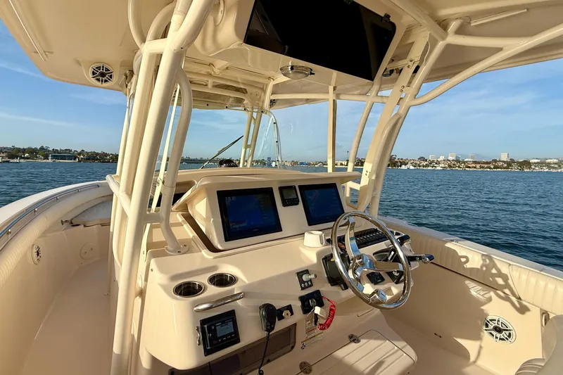 Slide: The Image of 2012 Grady-White Canyon 336 boat helm with modern controls on open water. - 41