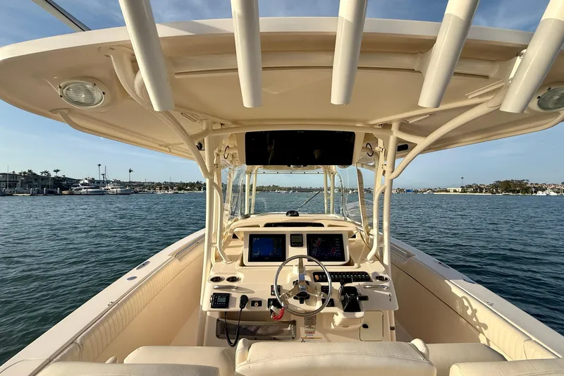 Slide: The Image of 2012 Grady-White Canyon 336 boat interior with helm, on calm water. - 42