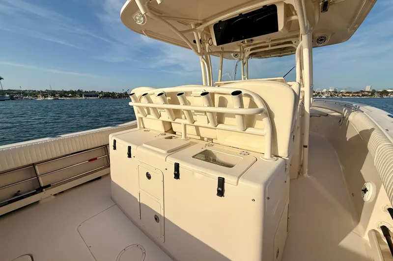 Slide: The Image of 2012 Grady-White Canyon 336 boat interior with rod holders and storage, docked by the water. - 44