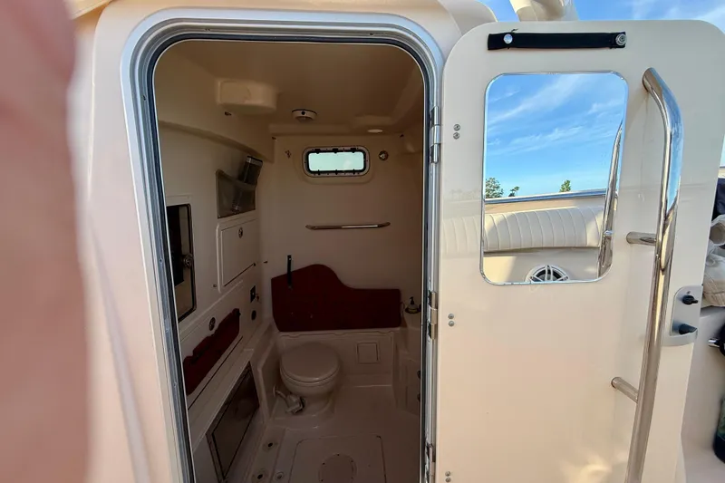 Slide: The Image of Interior view of 2012 Grady-White Canyon 336 boat bathroom with open door. - 46