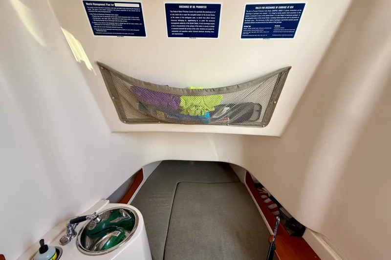 Slide: The Image of Interior cabin of 2012 Grady-White Canyon 336 boat with sink and storage net. - 47