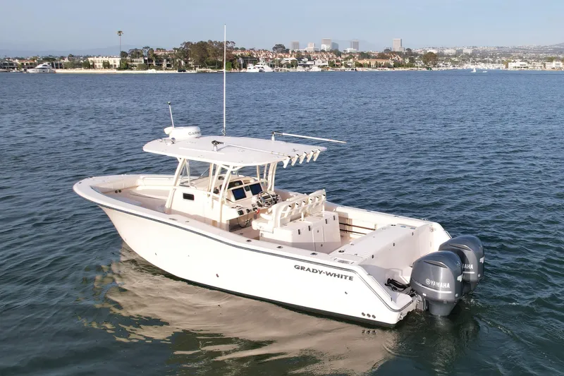 Slide: The Image of 2012 Grady-White Canyon 336 boat on calm water, cityscape in background. - 5