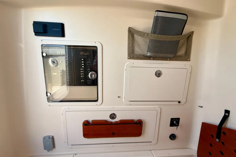 Slide: The Image of Control panel and storage compartments on a 2012 Grady-White Canyon 336 boat. - 50