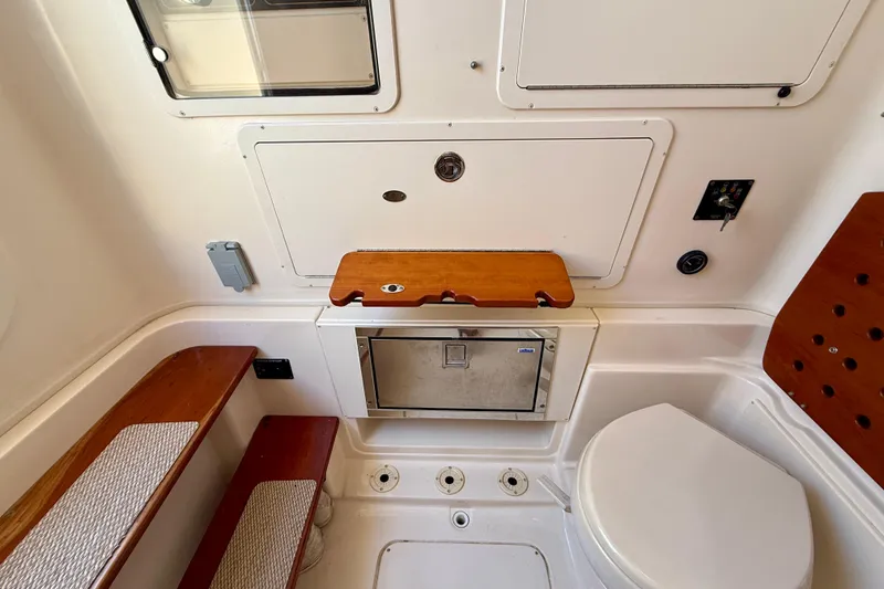 Slide: The Image of Interior of 2012 Grady-White Canyon 336 boat, featuring seating and storage compartments. - 51