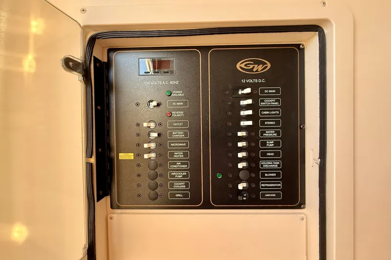 Slide: The Image of Electrical panel of 2012 Grady-White Canyon 336 boat, featuring AC and DC switches. - 53
