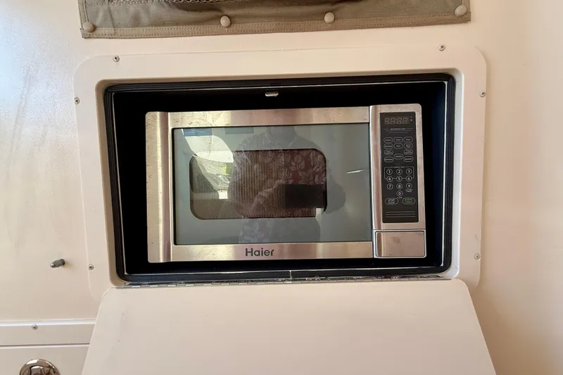 Slide: The Image of Built-in Haier microwave inside a 2012 Grady-White Canyon 336 boat. - 55