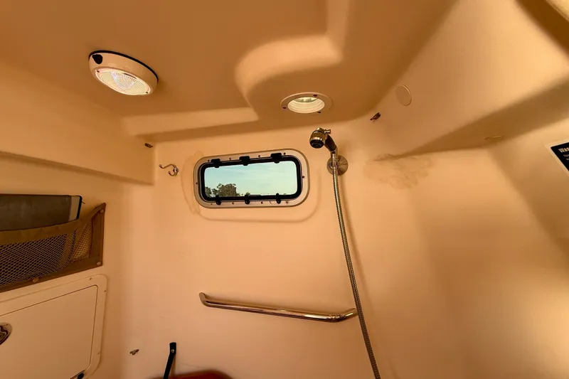 Slide: The Image of Interior of 2012 Grady-White Canyon 336 boat cabin with window and showerhead. - 56