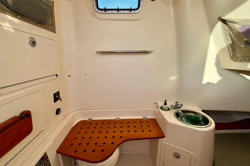 Slide: The Image of 2012 Grady-White Canyon 336 boat interior with sink and storage compartments. - 57