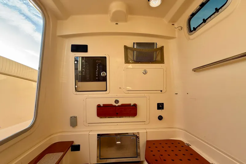 Slide: The Image of Interior cabin of 2012 Grady-White Canyon 336 boat, featuring storage compartments and seating. - 58