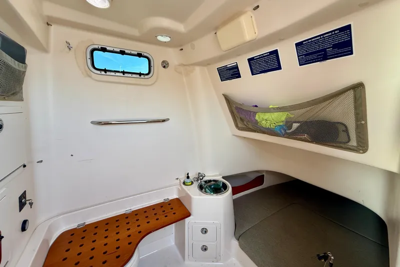Slide: The Image of Interior cabin of 2012 Grady-White Canyon 336 boat with storage and seating. - 60
