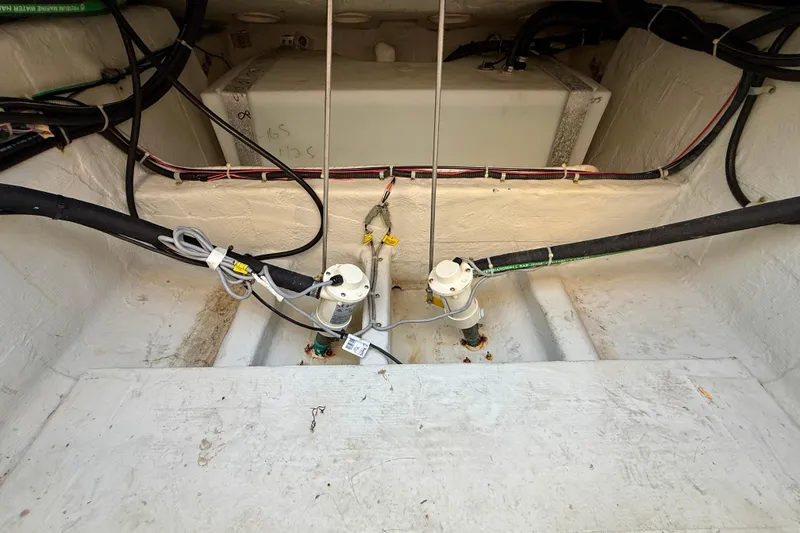 Slide: The Image of Bilge area of a 2012 Grady-White Canyon 336 boat, showing pumps and wiring. - 61
