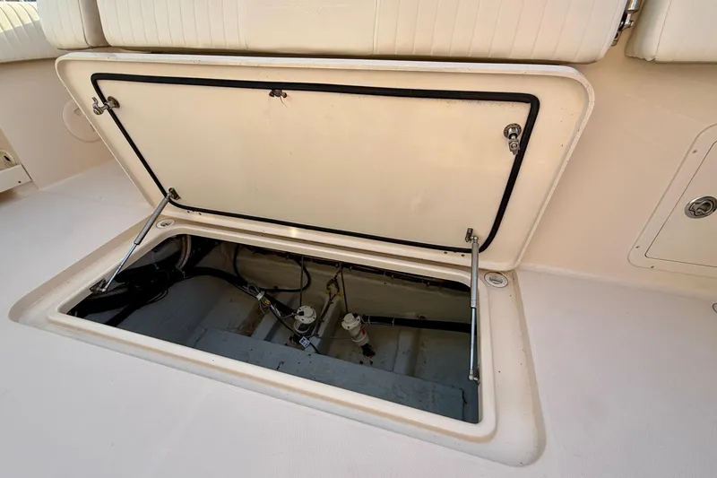 Slide: The Image of Open hatch on 2012 Grady-White Canyon 336 boat deck, revealing interior components. - 63