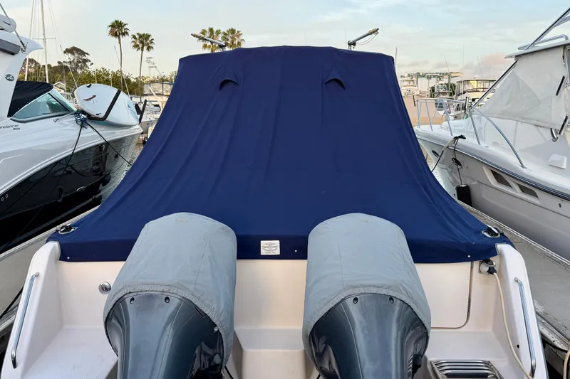 Slide: The Image of 2012 Grady-White Canyon 336 boat with covered engines, docked at a marina. - 66