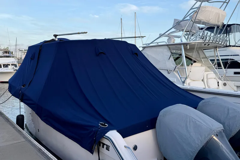 Slide: The Image of 2012 Grady-White Canyon 336 boat covered with a blue tarp at a marina. - 67