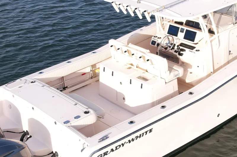 Slide: The Image of 2012 Grady-White Canyon 336 boat on water, featuring spacious deck and modern controls. - 8