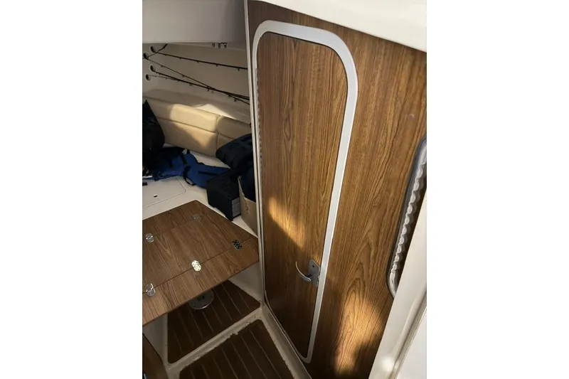 Slide: The Image of Interior of 2005 Scout 280 Abaco boat with wood finish and fishing rods. - 2